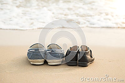 Farther's shoes and son's shoes on thes beac Stock Photo