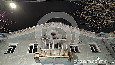 Fasade of house of merchant with balcony at night time Stock Photo