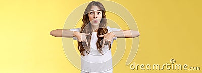 Fascinated impressed charismatic brunette female curly long haircut folding lips whistle astonished react excited Stock Photo