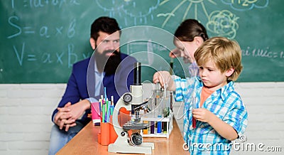 Fascinating chemical reaction. Teacher and pupils with test tubes in classroom. Interesting school classes. School Stock Photo