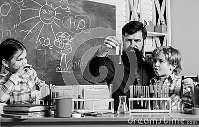Fascinating chemical reaction. Teacher and pupils test tubes in classroom. Interesting school classes. School education Stock Photo