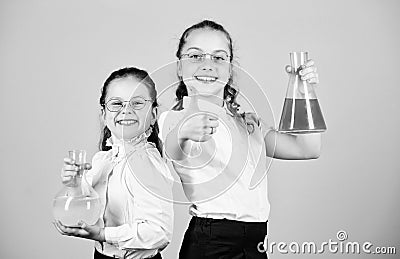 Fascinating experiment. Basic knowledge. Knowledge day. Schoolgirls friends with chemical liquids. Childhood and Stock Photo