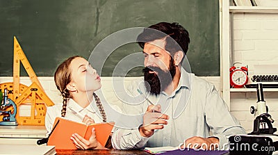 Fascinating lesson. School teacher and schoolgirl. Pedagogue skills. Talented pedagogue. Work together to accomplish Stock Photo