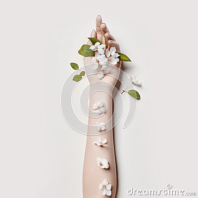 Fashion art hand woman in summer time and flowers on her hand with bright contrasting makeup. Creative beauty photo hand girls Stock Photo