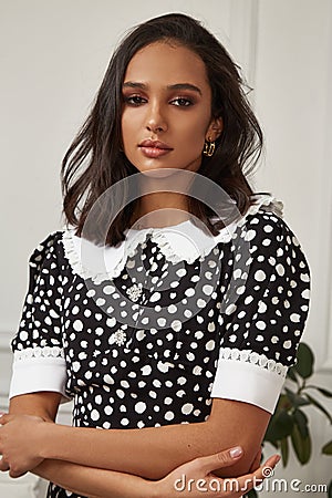 Fashion beautiful model sexy pretty lady dark tanned skin woman brunette hair wear black white dress clothes casual office style Stock Photo