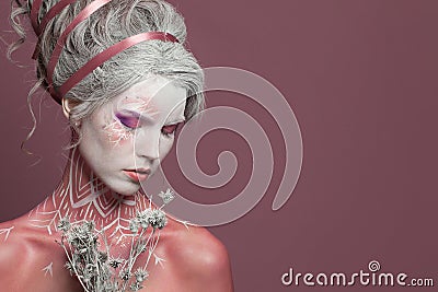 Fashion beauty portrait of glamorous woman Snow Queen or Winter Witch with white perfect fantasy makeup and painted body on pink Stock Photo