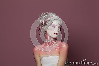 Fashion beauty portrait of young adult woman with Halloween makeup on pink background Stock Photo