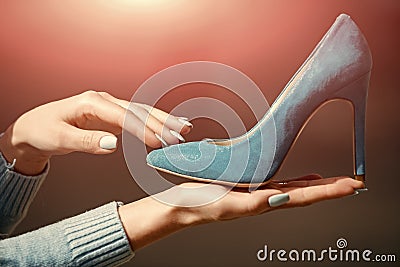 Fashion and beauty, shopping and presentation, cinderella. hand with glamour female shoe blue color suede Stock Photo