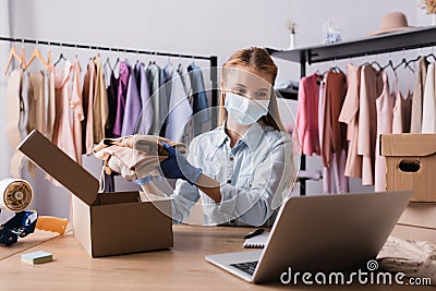 fashion boutique owner in medical mask Stock Photo