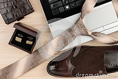 Fashion and business, notebook, shoes, cufflinks, tie on a wooden table as background. Stock Photo