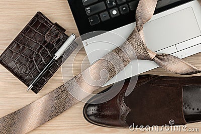 Fashion and business, notebook, shoes and tie on a wooden table as background Stock Photo