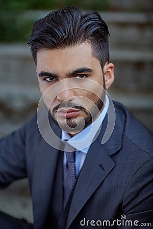 Fashion businessman sit down on old stairway Stock Photo