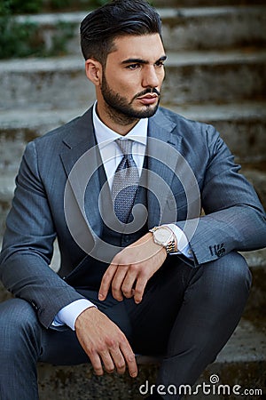 Fashion businessman sit down on old stairway Stock Photo