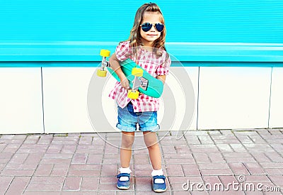 Fashion child holds skateboard in the city Stock Photo