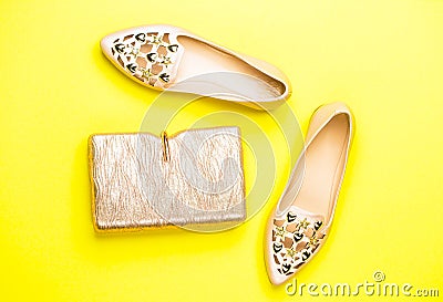 Fashion concept. Handbag, shoes isolated on yellow background, fashion. Top view. Pair of shoes and bag. Fashion and Stock Photo