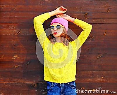 Fashion cool girl in colorful clothes over wooden background Stock Photo