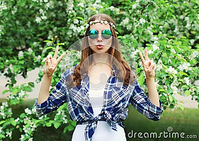 Fashion cool hippie woman having fun in flowering garden Stock Photo