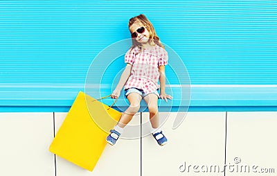 Fashion cool kid with shopping bag on colorful blue background Stock Photo