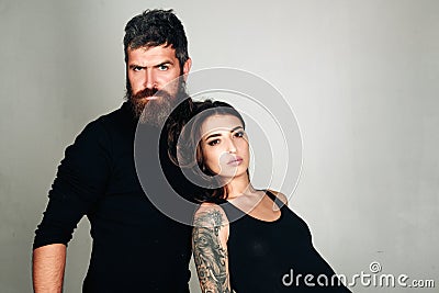 Fashion couple. couple in love. brutal bearded man and woman with tattoo. hairdresser and barbershop. tattoo salon. male Stock Photo