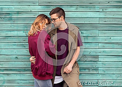 Fashion couple in their glasses with burgundy clothes posing on Stock Photo