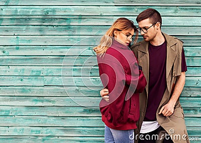 Fashion couple in their glasses with burgundy clothes posing on Stock Photo