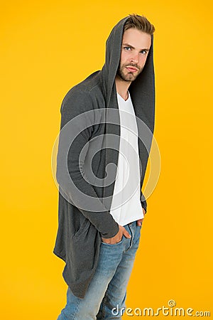 Fashion design gives sporty feel. Fashion man yellow background. Handsome guy wear hooded sweatshirt. Fashion model with Stock Photo