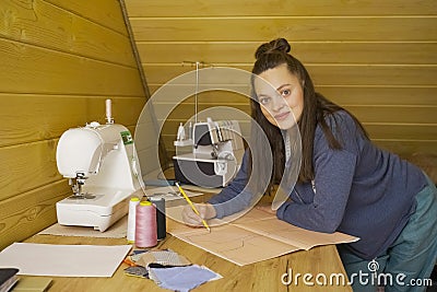 A fashion designer draws a sketch of a clothing collection on graph paper. Stock Photo