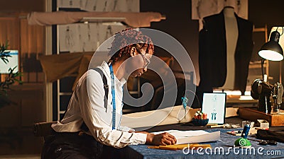 Fashion designer works on clothing items Stock Photo