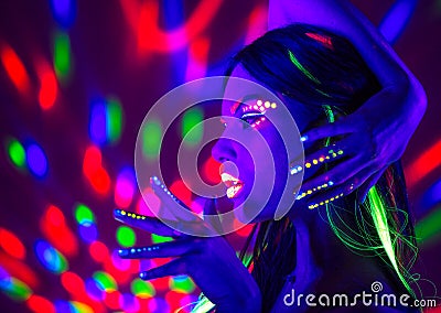 Fashion disco woman. Dancing model in neon light, portrait of beauty girl with fluorescent makeup Stock Photo