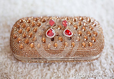 Fashion earrings style red jewels with diamonds on golden purse Stock Photo