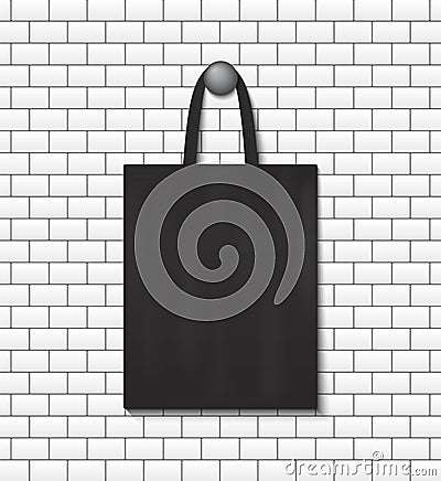 Fashion eco tote bag mockup hanging on wall background. School handbag for reusable. Black canvas sack with handles. Cotton Stock Photo