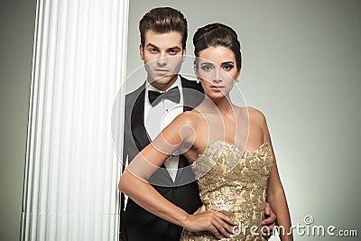 Fashion elegant couple man in tuxedo and woman near column Stock Photo