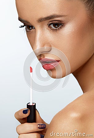 Fashion Female Model With Beauty Face Applying Lip Balm On Lips Stock Photo