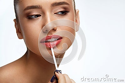 Fashion Female Model With Beauty Face Applying Lip Balm On Lips Stock Photo