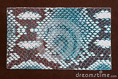 Fashion genuine leather sample embossed under exotic skin reptile dark turquoise color on dark background Stock Photo