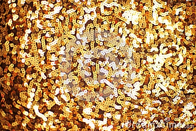 Fashion golden sequins, sparkling sequined textile. Gold background. Stock Photo