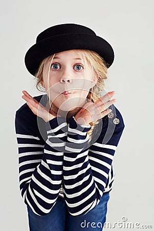 Fashion, goofy and girl child in a studio with casual, cool and stylish jersey outfit and hat. Silly, comic and funny Stock Photo
