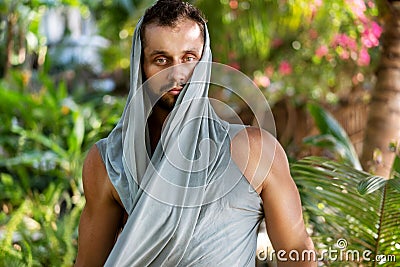 Fashion guy in the jungle is posing in his robes Stock Photo