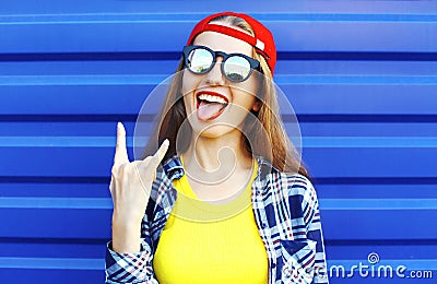 Fashion hipster cool girl in sunglasses and colorful clothes having Stock Photo