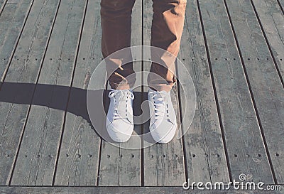 Fashion hipster cool man with white sneakers, soft vintage toned Stock Photo