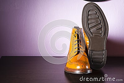 Fashion Ideas. Pair Male Tanned Leather Broggued Boots With One Shoe Turned Over. Stock Photo