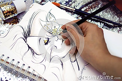 Fashion illustrator drawing a sketch with glitter Stock Photo