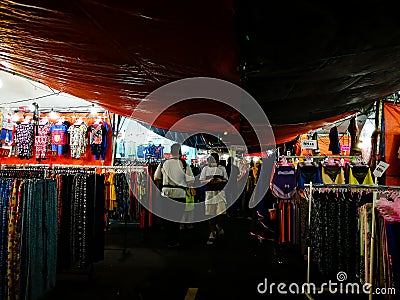 Fashion for kids and adults sold at a market. Editorial Stock Photo