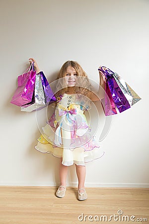 Fashion kids shopping. Beautiful smiling little girl Stock Photo