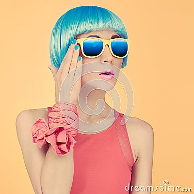 Fashion lady surprise in a blue wig and sunglasses Stock Photo