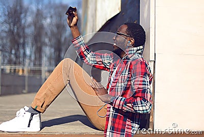 Fashion lifestyle photo happy young african man makes selfie Stock Photo