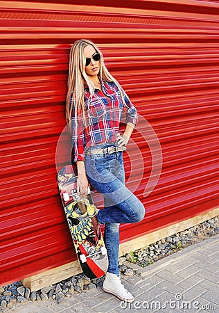 Fashion lifestyle portrait, beautiful young woman with skateboard outdoor Stock Photo
