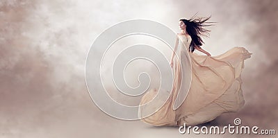 Fashion model in beautiful beige flowing chiffon dress Stock Photo