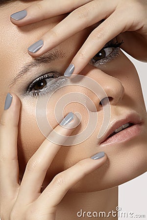 Fashion model face with shiny silver make-up, purity skin & grey nails manicure Stock Photo