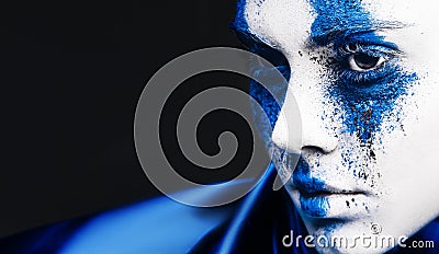 Fashion model girl portrait with colorful powder make up. woman with bright blue makeup and white skin. Abstract fantasy Stock Photo